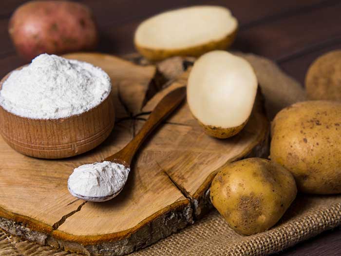 A Wooden Bowl and Spoonful of Potato Flour