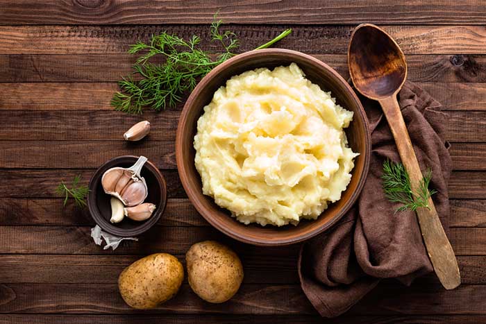 Bowl of Creamy Mashed Potato in Wooden table