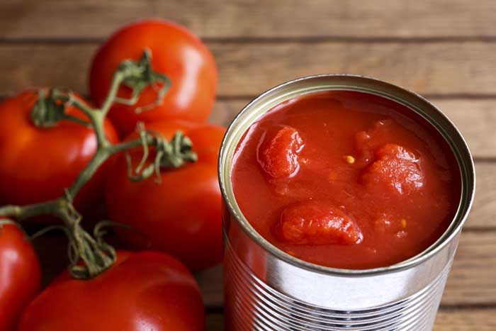Canned Tomatoes with fresh tomatoes on the side