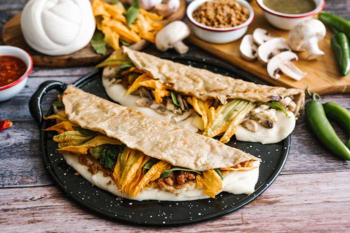 Chicharron and mushroom quesadillas with squash blossom