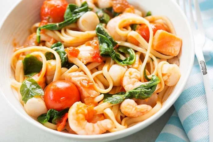 Seafood linguine with prawns, scallops and salmon, spinach