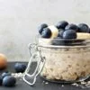Overnight oats with fresh blueberries and bananas in jars