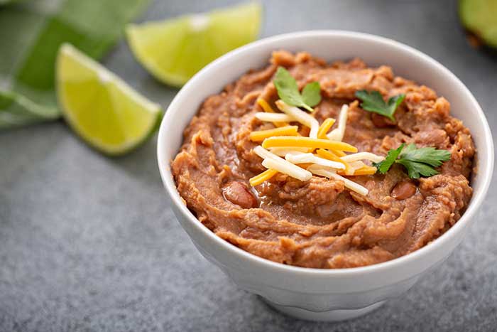 Refried beans in a white bowl mexican dish