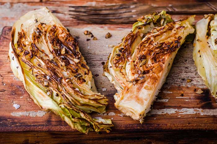 Roasted Cabbage Steaks in a Wooden Chopping Board