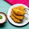 Traditional mexican jalapeno poppers stuffed with cheese and breaded
