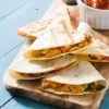 cheese quesadillas served on wooden chopping board