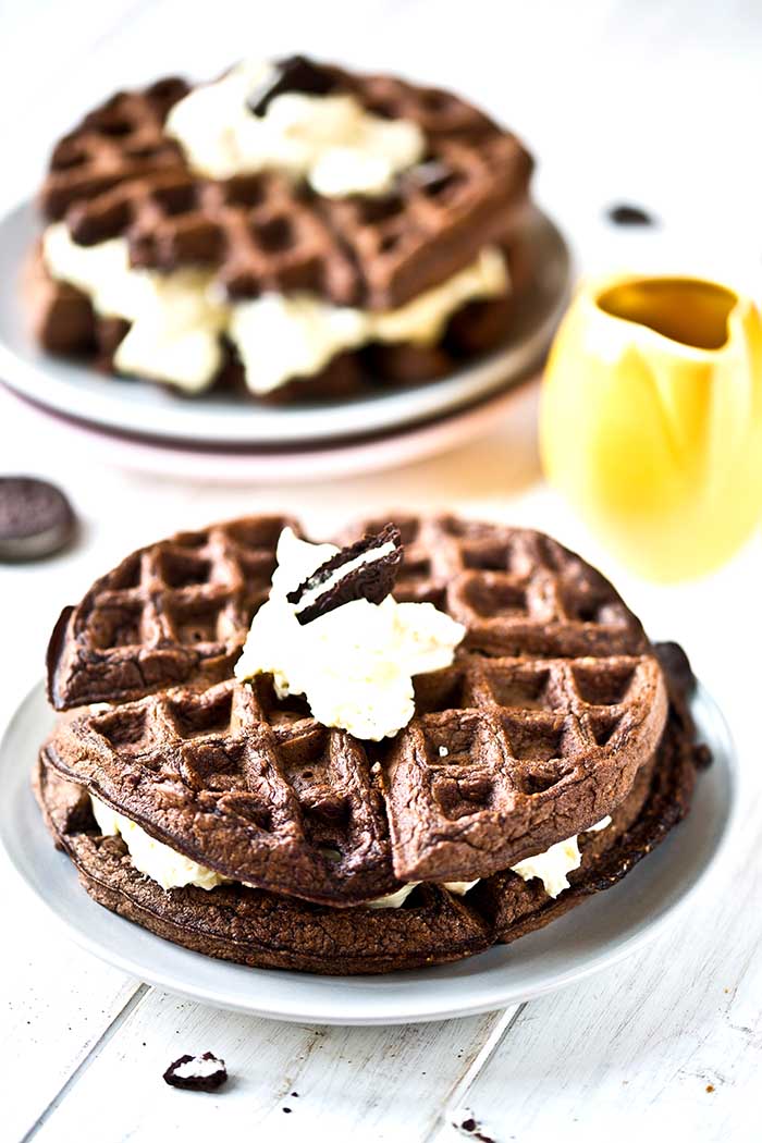 oreo waffles made from chocolate cookie batter and topped with whipped cream
