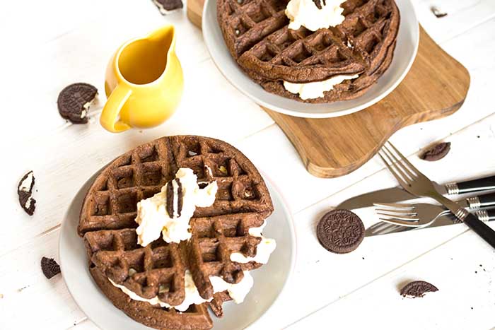 oreo waffles made from chocolate cookie batter and topped with whipped cream