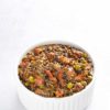 Black lentil curry on white bowl isolated on white background