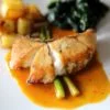 chilean sea bass fillet steak with potatoes and spinach in lemon sauce