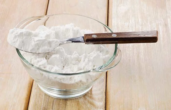 potato starch in a glass bowl on wooden table