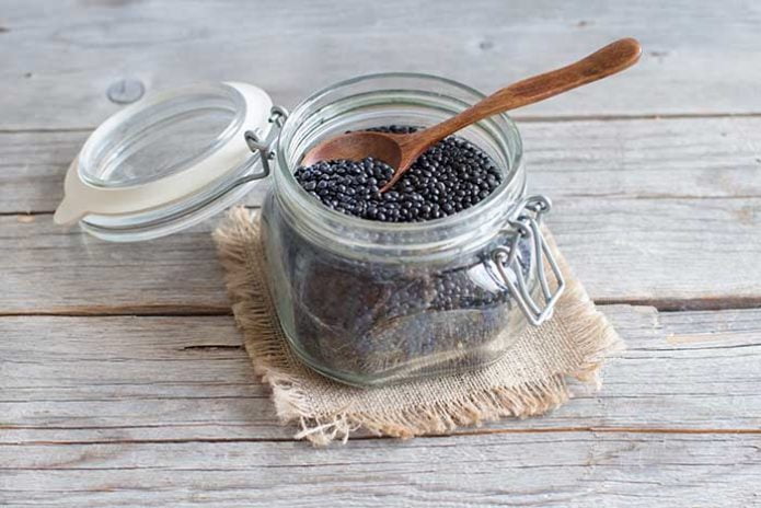 raw black lentils in small mason jar