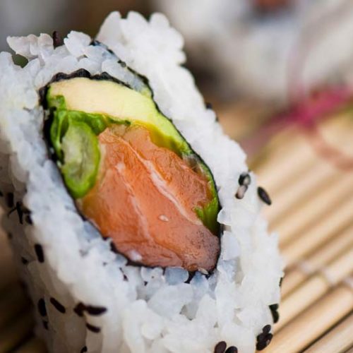 salmon sushi rolls in sriacha mayo and nori sheets
