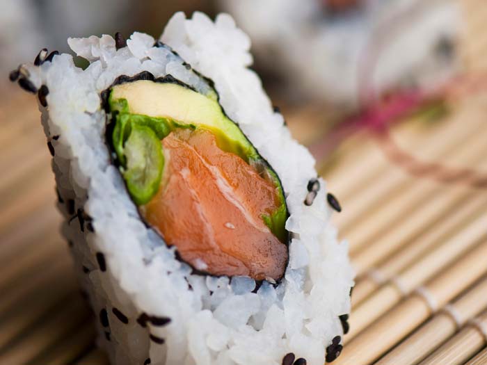 salmon sushi rolls in sriacha mayo and nori sheets