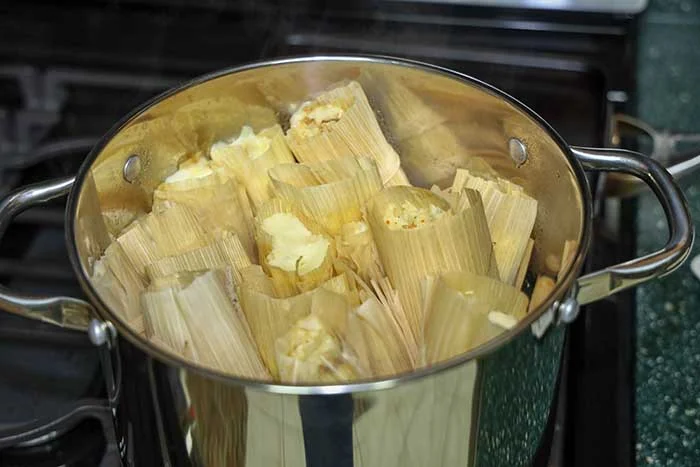 View of cooked tamales inside pot.