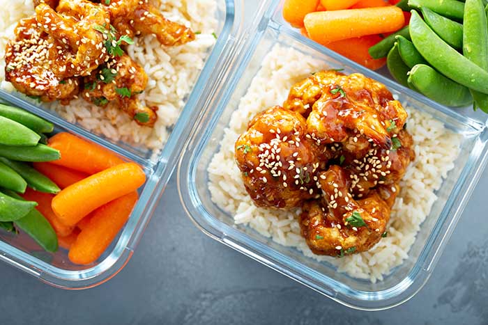vegan meal prep with bbq cauliflower rice carrots and sugar peas