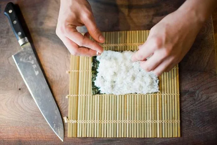 wrapping sushi rice in nori sheet